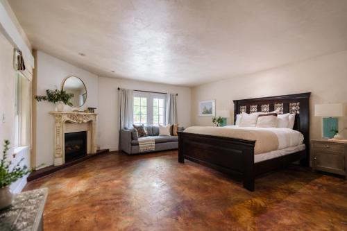 a bedroom with a large bed and a fireplace at Estrella by AvantStay Secluded Spanish-Style Estate on 7 Acres of Vineyards in Windsor