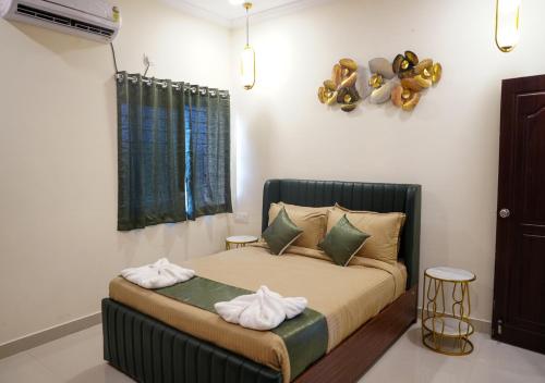 a bedroom with a bed with towels on it at Hotel Urban Sleep Airport Zone in Shamshabad