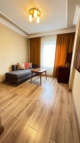 a living room with a couch and a table at Grand Hotel Seferoğlu in Istanbul