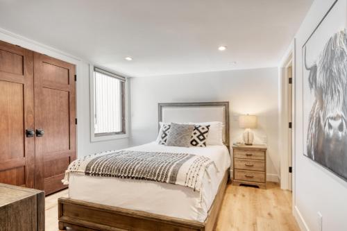 a bedroom with a bed and a dresser and a window at Quicksilver by AvantStay Park City Town House in Great Location in Park City