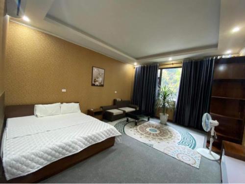a bedroom with a large bed and a window at Cô Chung Hotel in Lao Cai