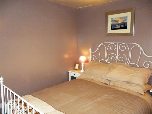 a bedroom with a bed with a white headboard at 1 bed in Kilmory CA344 in Kilmory