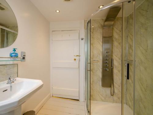 a bathroom with a shower and a sink at 3 Bed in Brodick 77585 in Brodick