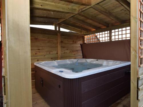 a jacuzzi tub in a room with wooden walls at 3 Bed in Melrose 76698 in Galashiels