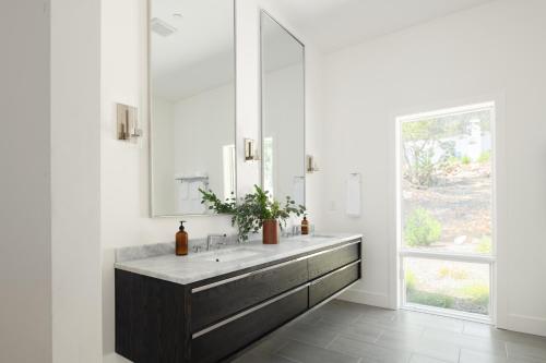 a bathroom with a sink and a mirror at Chardonnay by AvantStay Modern Private Haven in Sonoma Infinity Pool w Valley Views in Sonoma