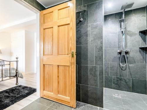 baño con ducha y puerta de madera en 2 Bed in Filey 79279 en Wold Newton