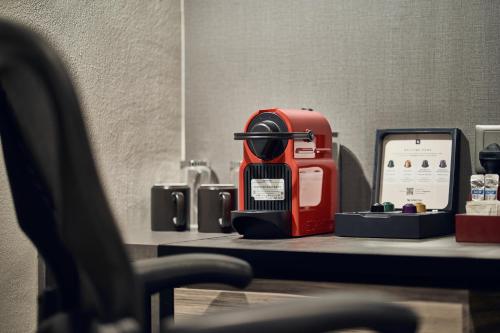 a red appliance sitting on top of a table at Novotel Singapore on Kitchener in Singapore
