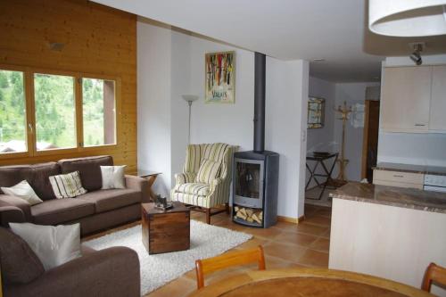 a living room with a couch and a fireplace at Télémark 7 in Zinal