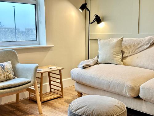 a living room with a couch and a chair at Barbican Loft - with Free parking in York