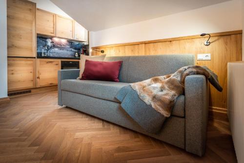 ハウス・イム・エンスタールにあるHaus Ennsegg by Schladming-Appartementsのリビングルーム(ソファ、毛布付)