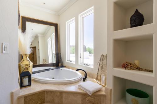 a bathroom with a tub and a large mirror at Opal by AvantStay Central Scottsdale Luxe Home in Scottsdale