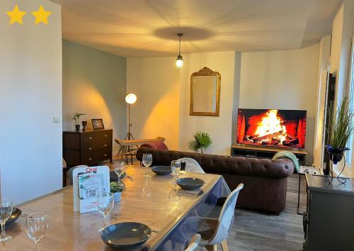 un salon avec une table et une cheminée dans l'établissement Le Roof Top Jacquard, à Calais