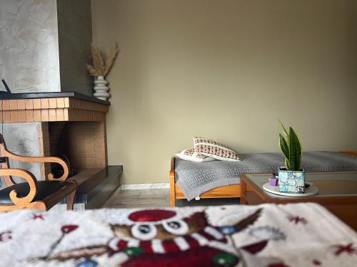 a living room with a bed and a fireplace at Lenio’s in Karistos