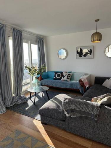 a living room with a couch and a table at Central Sea View maisonette in Hastings