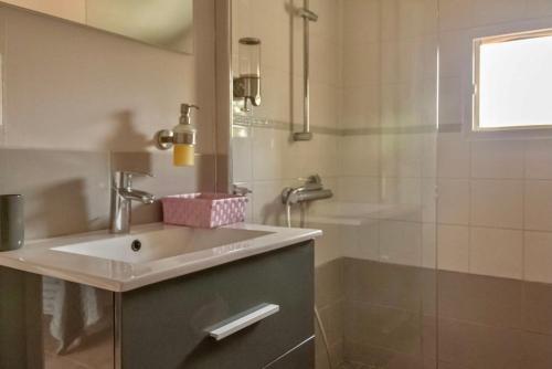 a bathroom with a sink and a shower at Mas Saint-Ange in Lunel