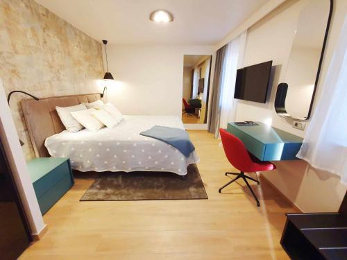 a bedroom with a bed and a desk and a computer at NEW Ana Design City Center Apartments in Pula