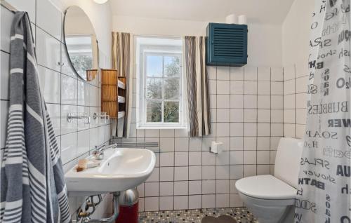 a bathroom with a sink and a toilet at Cozy Home In Fan With Kitchen in Fanø