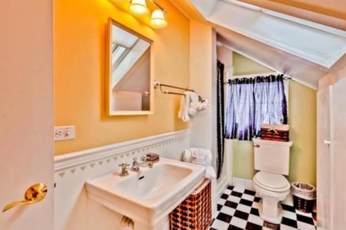 a bathroom with a sink and a toilet at Casa de Rosalie by AvantStay Great Location w Pool BBQ Outdoor Dining Month Long Stays Only in Key West