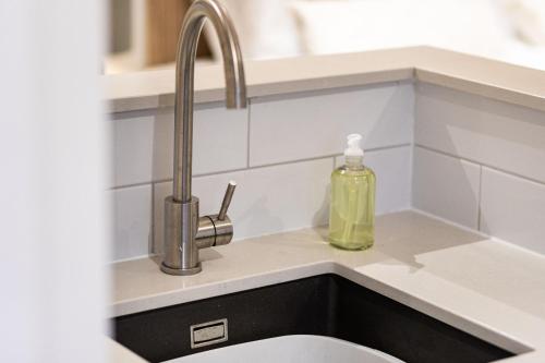 a kitchen sink with a soap bottle next to it at Rock Mill Apartment 9 in Stoney Middleton