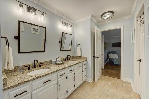a bathroom with two sinks and a mirror at A Frame of Mind by AvantStay Private Dock View in Lake Norman of Catawba
