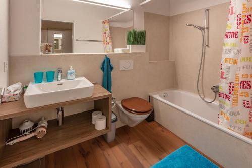 a bathroom with a sink and a toilet and a shower at Andi's BnB in Zug