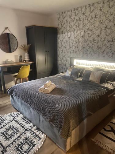a bedroom with a bed with two towels on it at APARTAMENT 1 Nad rzeką Krutyń in Babięta