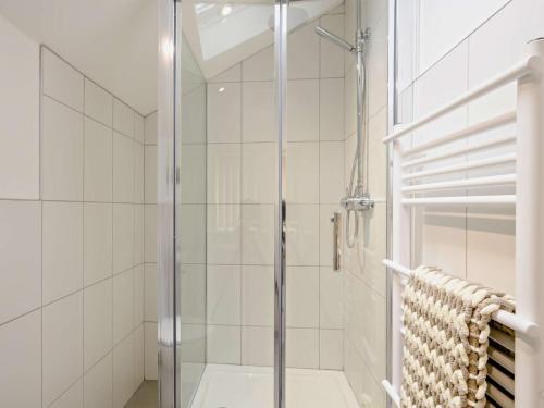 a shower with a glass door in a bathroom at 3 Bed in Wroxham 83034 in Worstead