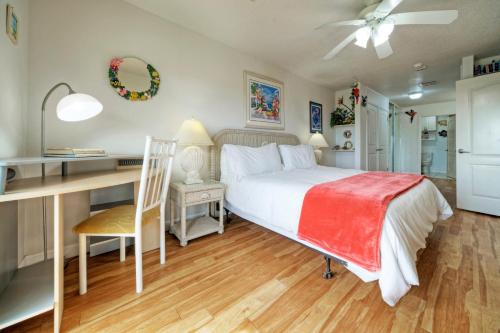 a bedroom with a bed and a desk and a desk at Salt Sun by AvantStay Beach Access Pool in Port Aransas