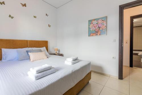 a bedroom with a bed with towels on it at Aurora Urban Condo in Heraklio Town