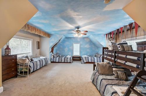 a room with three beds and a blue ceiling at Family Lake House Retreat by AvantStay Sleeps 28 in Mooresville