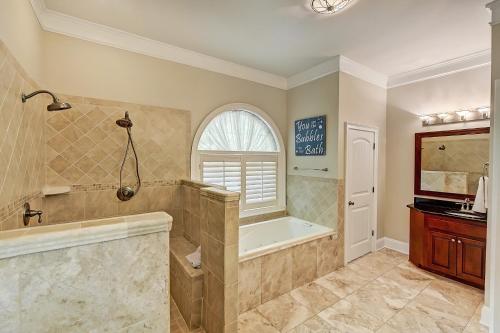 a large bathroom with a tub and a sink at Family Lake House Retreat by AvantStay Sleeps 28 in Mooresville