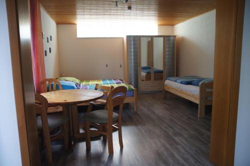 NittenauにあるFerienapartment Ackermannのテーブルと椅子、ベッドルーム1室が備わります。