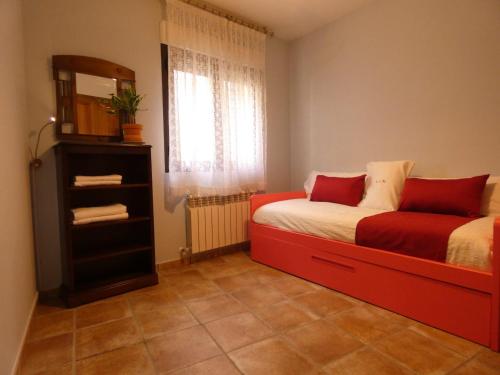 a bedroom with a bed and a mirror and a window at Lar de María in Villacastín