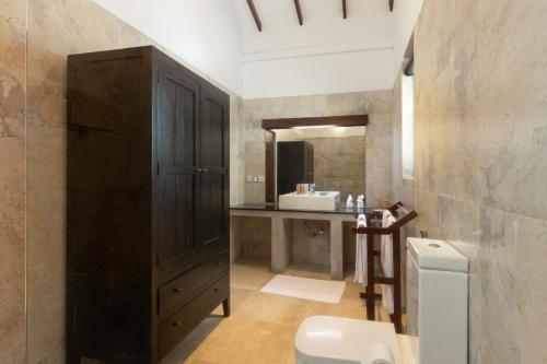 a bathroom with a toilet and a sink at Parangi Weligama Bay - Thema Collection in Weligama