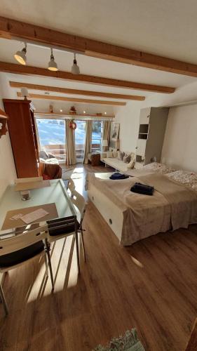 a large bedroom with two beds and a desk at Berghof Appartement 11 in Ellmau