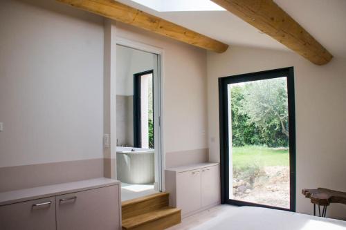 a room with a large window in a house at Villa des jacinthes in Tarascon