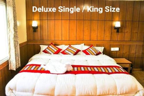 a large bed in a room with a large white bed sidx sidx sidx at Hotel Grand Shambala in Muktināth
