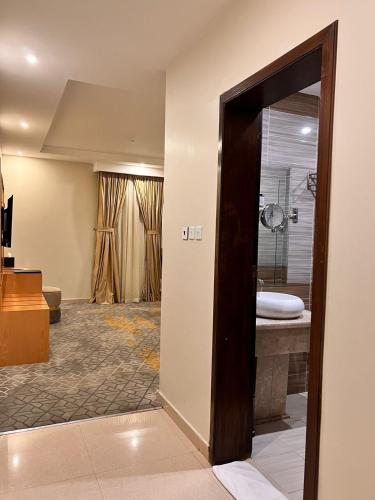 a room with a bathroom with a tub and a sink at Hotel AlMuhaidb Residence Alkhafji in Khafji