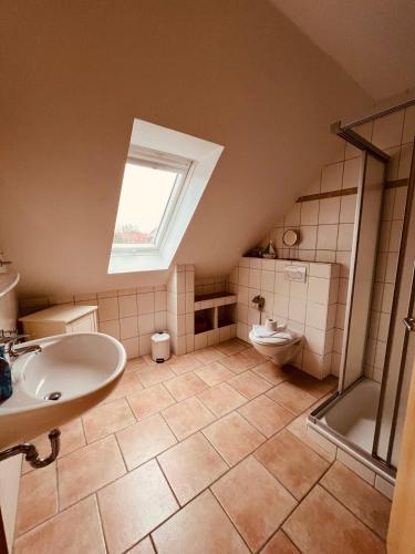 a bathroom with a sink and a toilet at Ferienhaus Dirka in Norddeich