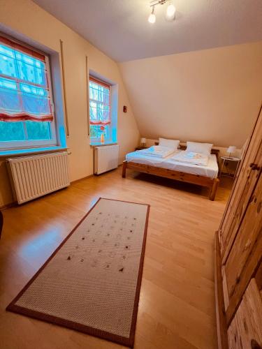 a bedroom with two beds and a large window at Ferienhaus Dirka in Norddeich