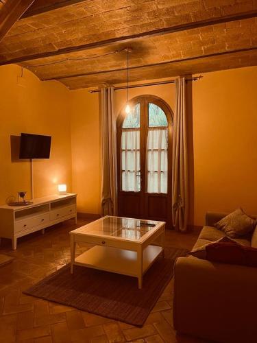 a living room with a couch and a coffee table at Podere Sant'Antonio in Buonconvento