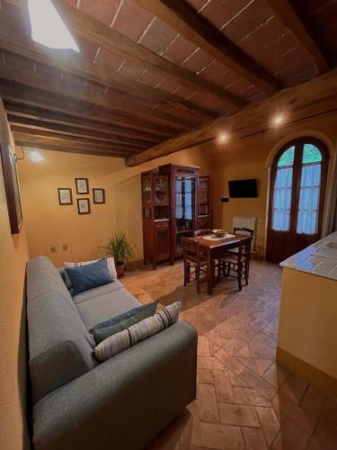 a living room with a couch and a table at Podere Sant'Antonio in Buonconvento