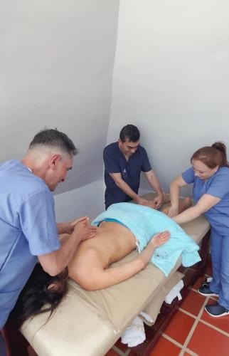 a group of people getting a patient on a bed at Monarca Azul Glamping in Villa de Leyva