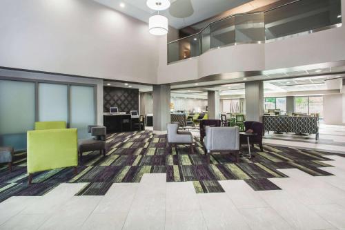 a lobby with chairs and tables in a building at La Quinta by Wyndham Clearwater South in Clearwater