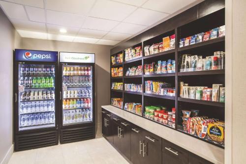 a grocery store aisle with soda and drinks at La Quinta by Wyndham Clearwater South in Clearwater