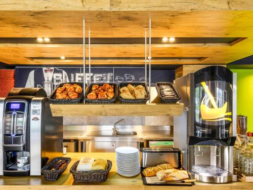 a bakery with many different types of pastries on a counter at Ibis budget Saint-Étienne stade in Saint-Étienne