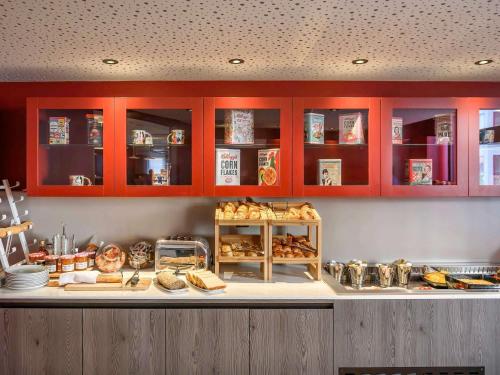 um balcão de padaria com muitos tipos diferentes de pão em Novotel Saint-Étienne Centre Gare Châteaucreux em Saint-Étienne