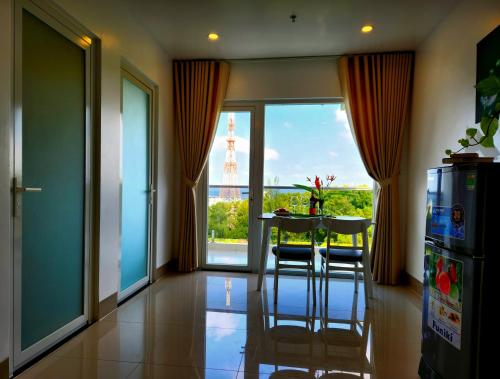a kitchen with a table and a view of the eiffel tower at Mi Amor Luxury Island Apartment - 3 minutes to the beach in Phu Quoc