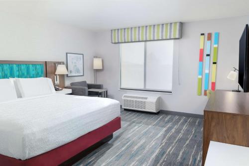 a hotel room with a bed and a window at Hampton Inn & Suites Imperial Beach San Diego, Ca in Imperial Beach