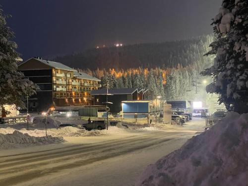 a ski lodge in the snow at night at Luxury Ski-in&Out &Private Jacuzzi (Levi Diamonds) in Sirkka